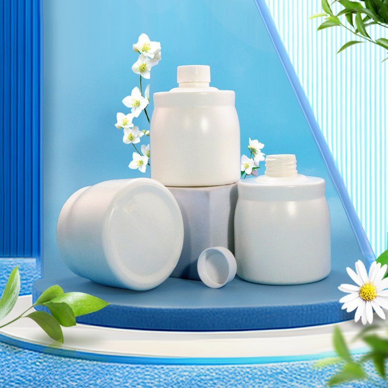 Three white PET cosmetic jars grouped on a clean surface, the kind of primary pack that is bundled into a multi-unit retail set or gift box with an insert tray
