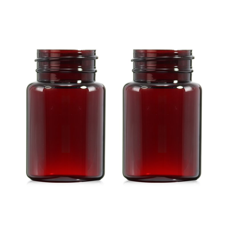 An 80ml amber PET cosmetic bottle photographed against a neutral background, representative of the PET and PETG fragrance and serum bottles where alcohol content triggers UN dangerous goods rules